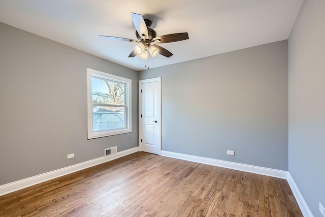 spare room featuring wood-type flooring and ceiling fan