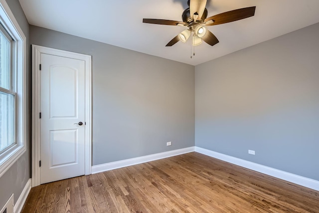 empty room featuring ceiling fan and light hardwood / wood-style floors