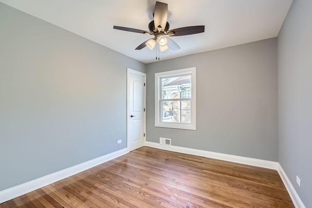 empty room featuring ceiling fan and wood-type flooring