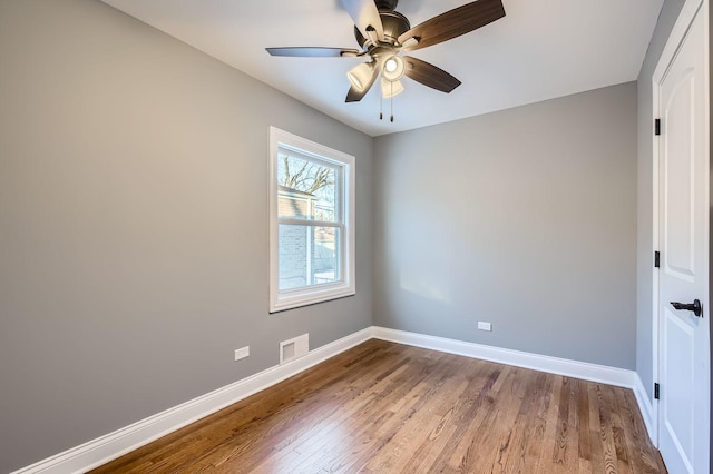 unfurnished room with light wood-type flooring and ceiling fan