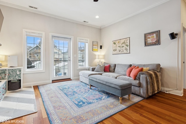 living room with crown molding and hardwood / wood-style flooring