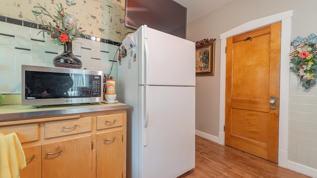 kitchen with light hardwood / wood-style floors and white refrigerator