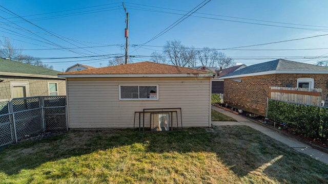 rear view of property with a yard