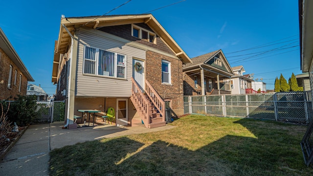 back of property with a patio area and a lawn