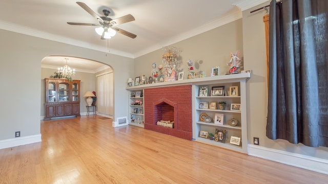 unfurnished living room featuring a brick fireplace, ceiling fan, crown molding, hardwood / wood-style flooring, and built in features