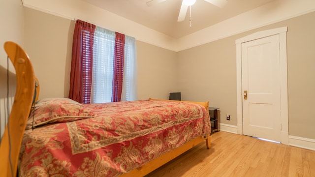 bedroom with light hardwood / wood-style floors and ceiling fan