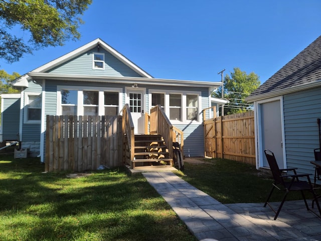 bungalow-style home with a patio and a front lawn