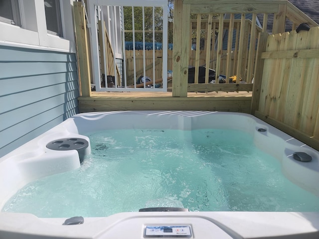 view of pool featuring a wooden deck and a hot tub