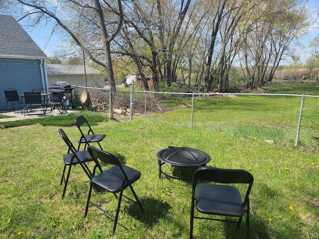 view of yard with an outdoor fire pit and a patio