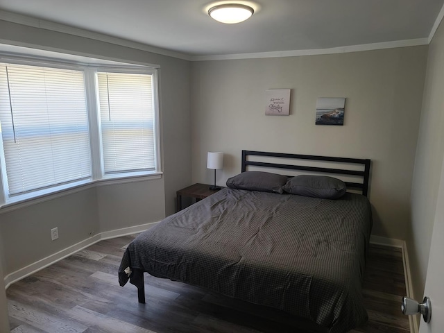 bedroom featuring hardwood / wood-style flooring and crown molding