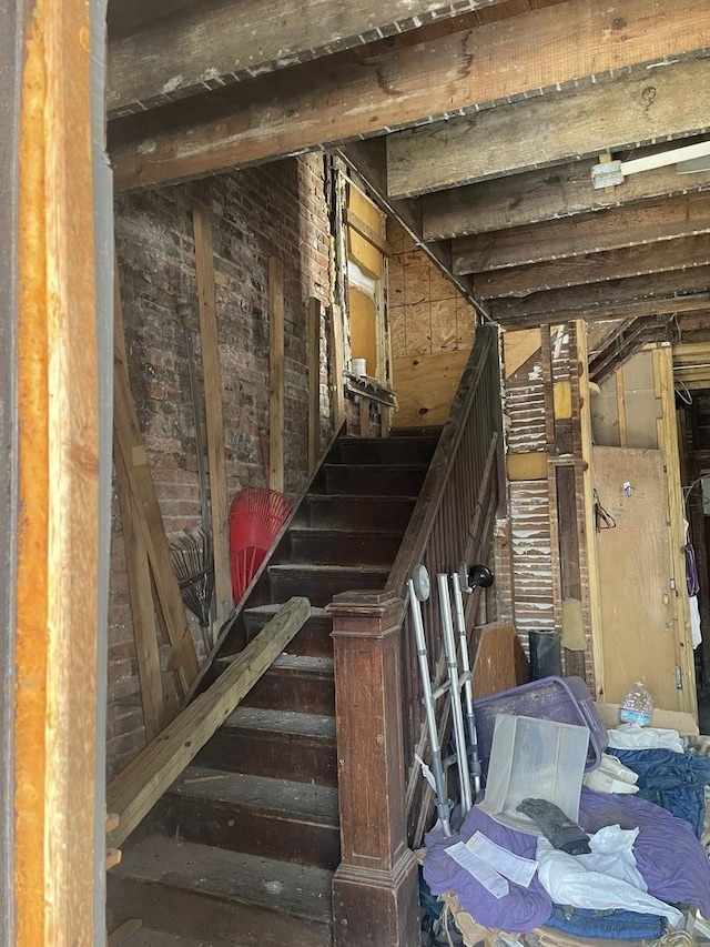 stairs featuring beam ceiling