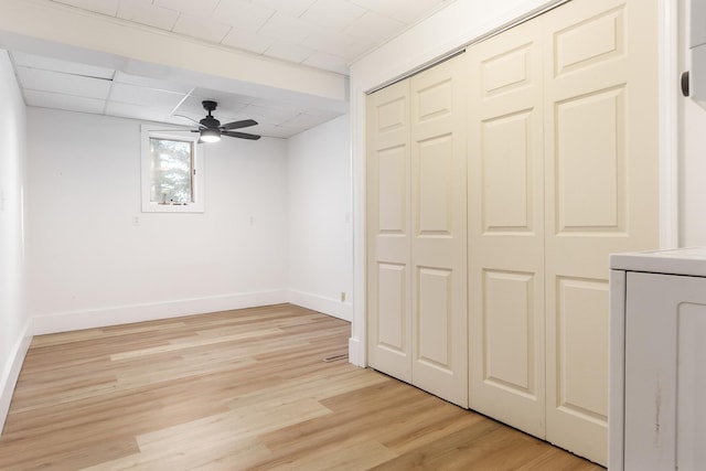 unfurnished bedroom featuring a paneled ceiling, light hardwood / wood-style floors, and ceiling fan