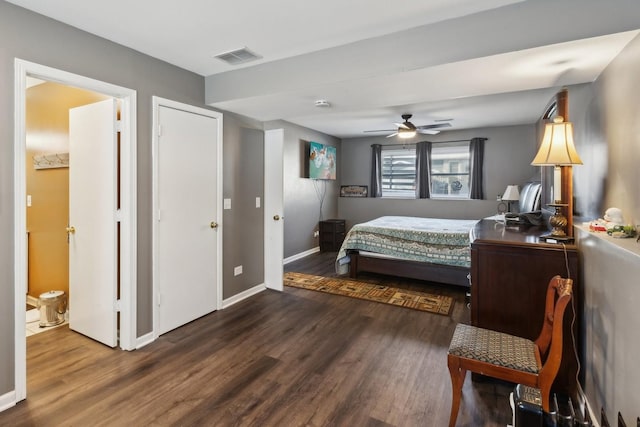 bedroom with dark hardwood / wood-style flooring, ensuite bath, and ceiling fan