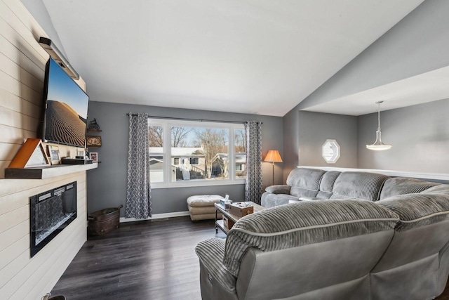 living room featuring dark wood-type flooring and vaulted ceiling