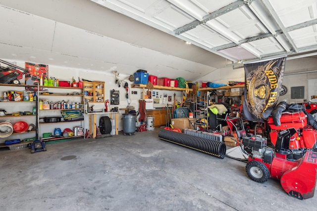 garage featuring electric panel and a workshop area