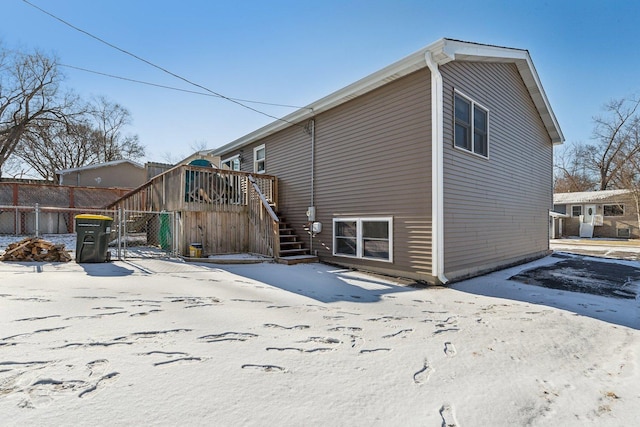 view of snow covered back of property