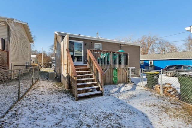 snow covered rear of property with central air condition unit