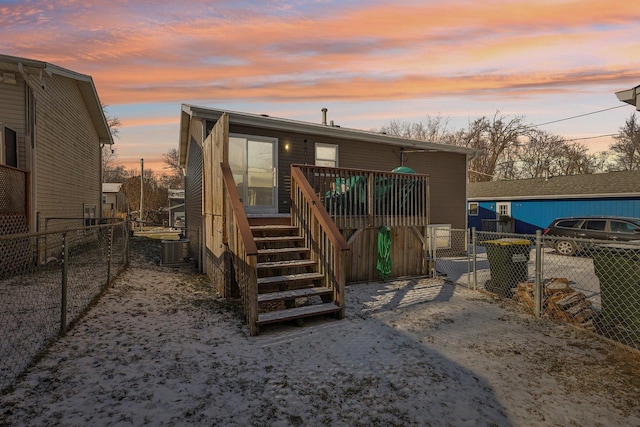 back house at dusk with central air condition unit