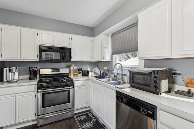 kitchen featuring white cabinets, stainless steel appliances, dark hardwood / wood-style flooring, and sink