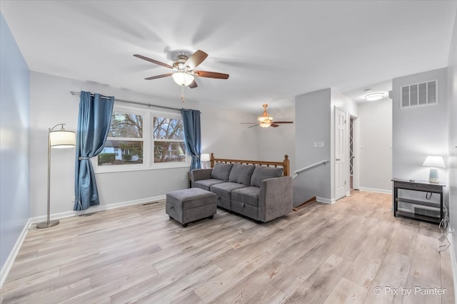 living room with ceiling fan and light hardwood / wood-style flooring