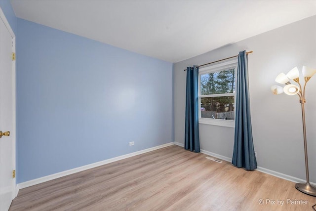 spare room featuring light hardwood / wood-style flooring