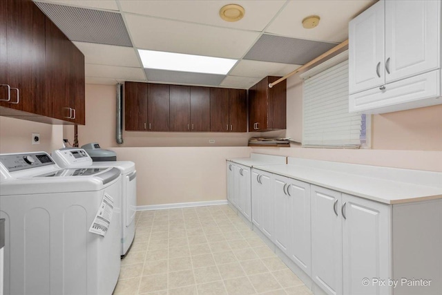 washroom with cabinets and washing machine and dryer