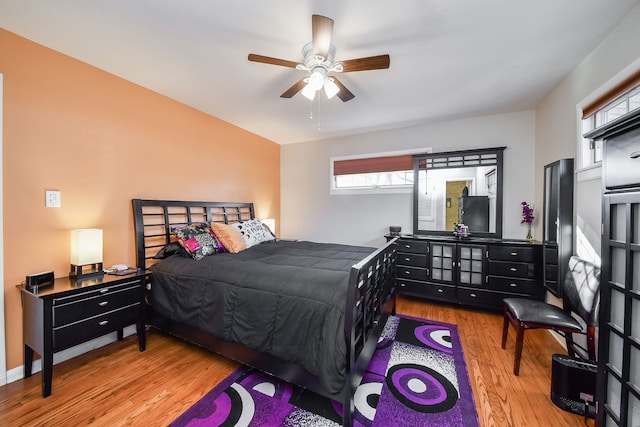 bedroom with ceiling fan and light wood-type flooring