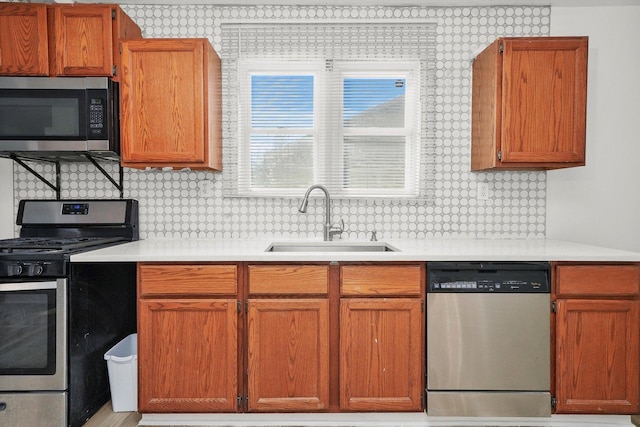 kitchen with backsplash, sink, and stainless steel appliances