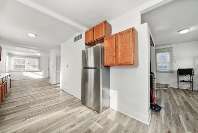 kitchen featuring stainless steel fridge and light wood-type flooring