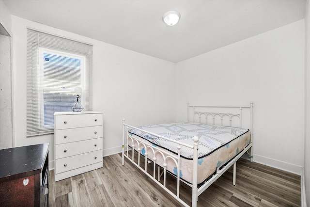 bedroom with hardwood / wood-style flooring