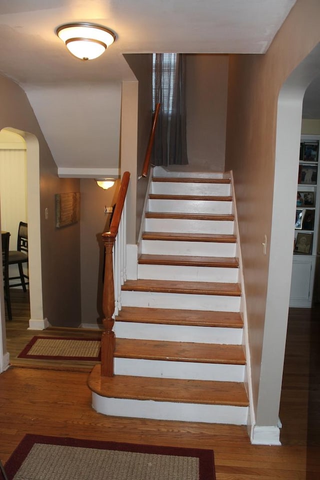 stairs with wood-type flooring