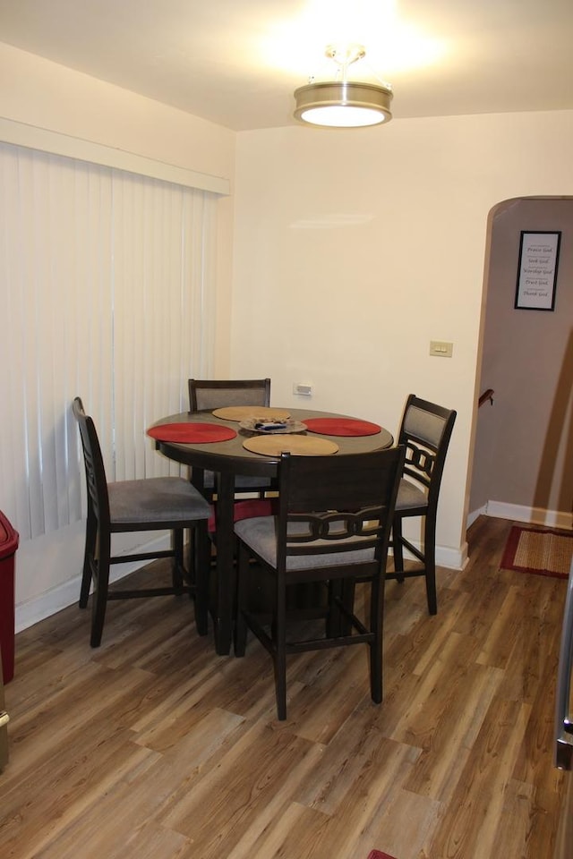 dining space with dark wood-type flooring