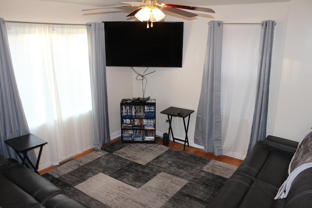 living room with hardwood / wood-style floors, a wealth of natural light, and ceiling fan