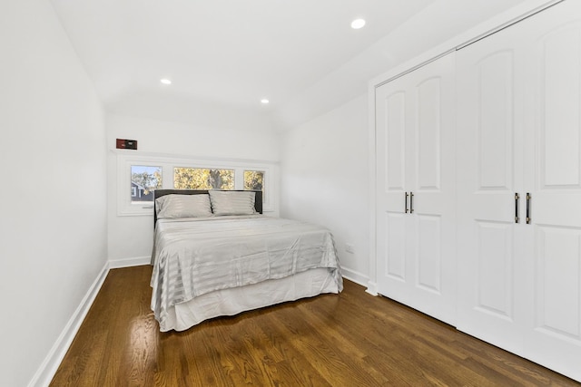 bedroom with dark wood-type flooring and a closet