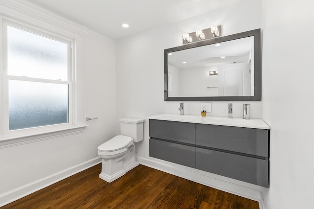 bathroom with vanity, wood-type flooring, and toilet