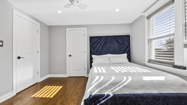 unfurnished bedroom featuring ceiling fan and dark hardwood / wood-style flooring