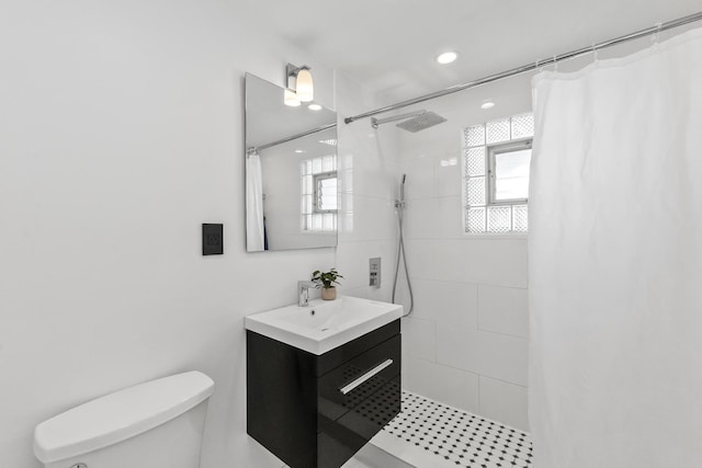 bathroom featuring a shower with curtain, toilet, and vanity