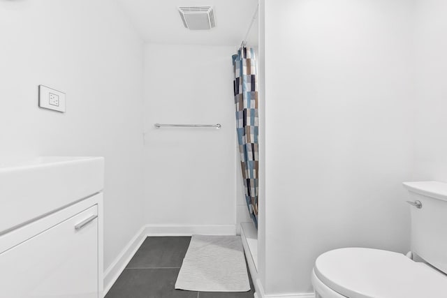 bathroom with a shower with shower curtain, tile patterned floors, vanity, and toilet