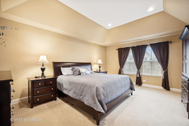 bedroom featuring a raised ceiling and light carpet