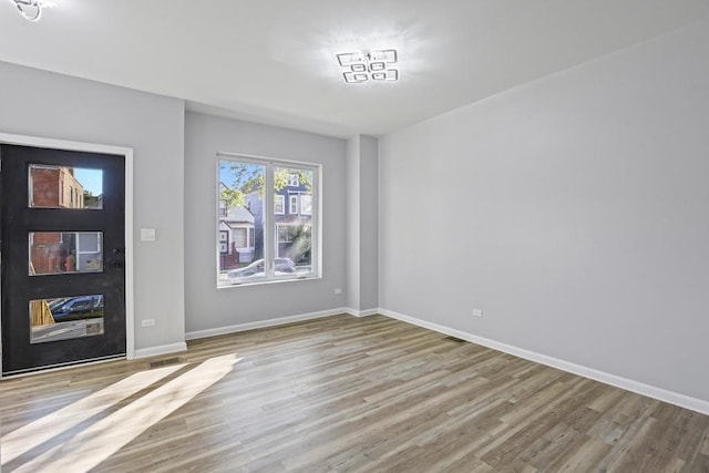 spare room with light hardwood / wood-style flooring