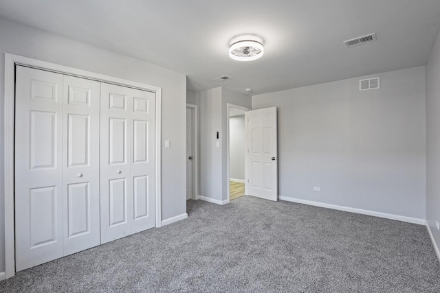 unfurnished bedroom featuring carpet and a closet