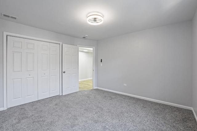 unfurnished bedroom with carpet floors and a closet