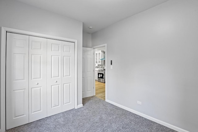 unfurnished bedroom featuring a closet and carpet floors