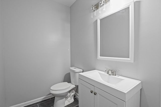 bathroom featuring tile patterned floors, vanity, and toilet