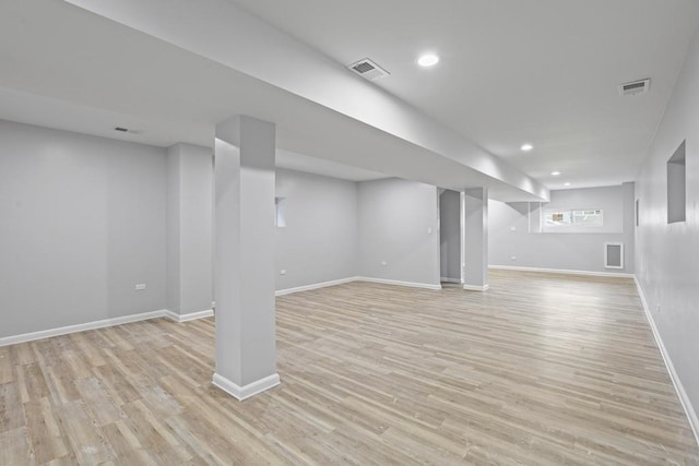 basement with light hardwood / wood-style flooring