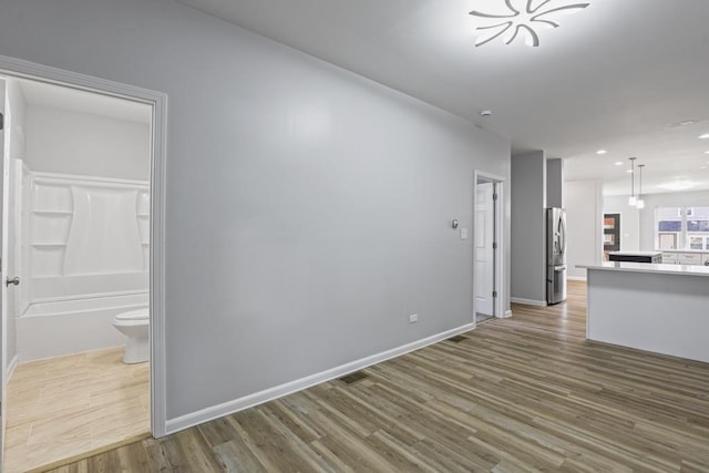 unfurnished living room with hardwood / wood-style floors