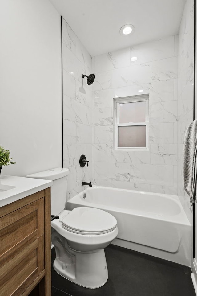 full bathroom with vanity, tiled shower / bath, and toilet