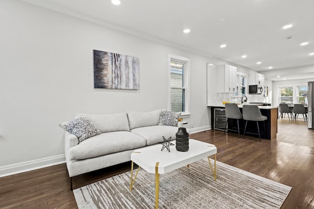 living room with crown molding and dark hardwood / wood-style flooring