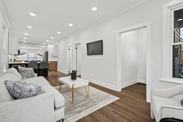 living room featuring dark hardwood / wood-style flooring and ornamental molding