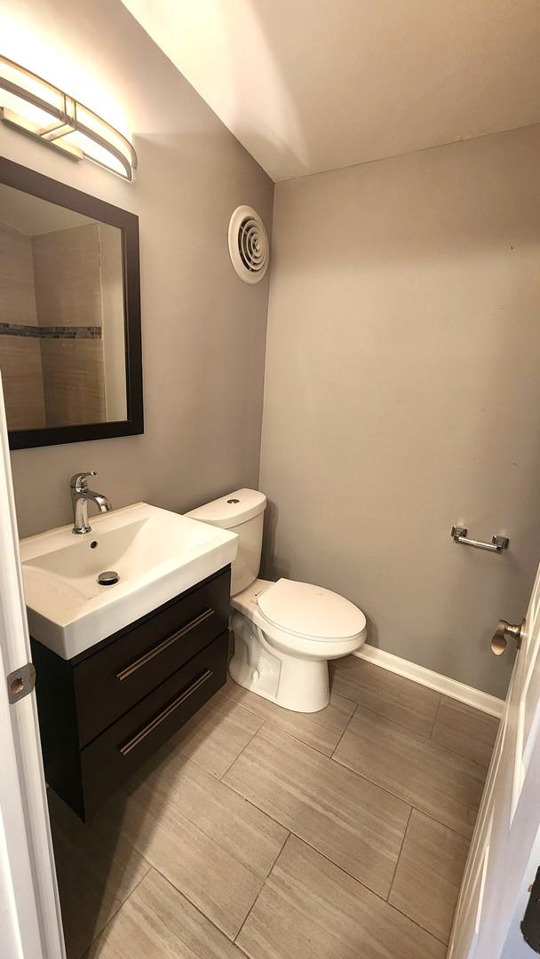 bathroom with toilet and vanity